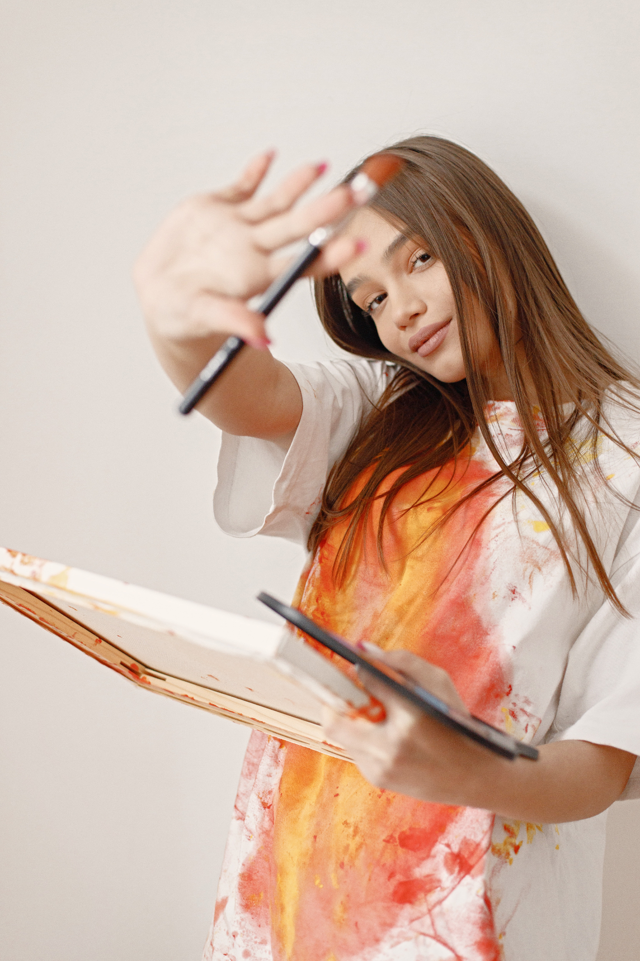 Young artist in the studio with canvas and brushes